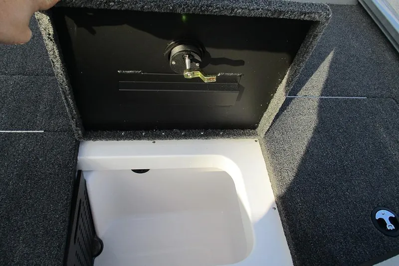 Slide: The Image of 2026 Vexus Defender 189 boat storage compartment with open lid, showcasing interior space. - 14