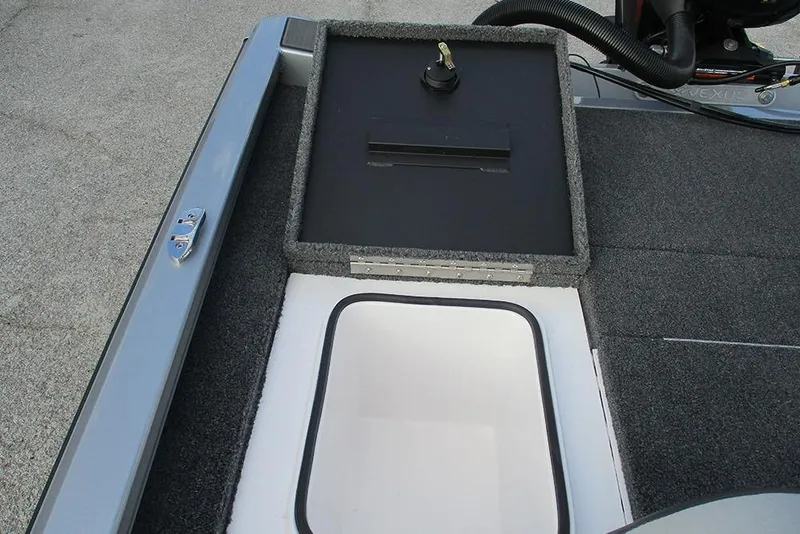 Slide: The Image of 2026 Vexus Defender 189 boat interior with storage compartment and carpeted deck. - 17