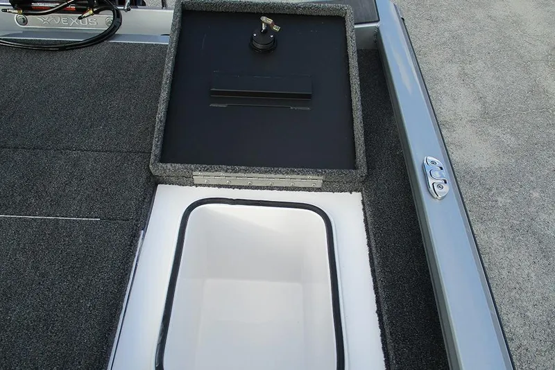 Slide: The Image of 2026 Vexus Defender 189 boat storage compartment with open lid and key. - 20