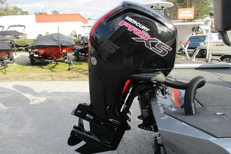 Slide: The Image of 2026 Vexus Defender 189 with Mercury Pro XS outboard motor in a boat dealership. - 3