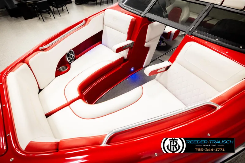 Slide: The Image of 2022 Crownline 220 LPX boat interior with red and white seating, Reeder-Trausch Marine logo. - 10