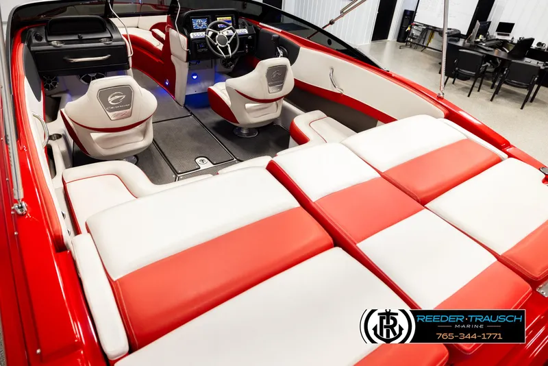 Slide: The Image of 2022 Crownline 220 LPX boat interior with red and white seating, modern dashboard, and steering wheel. - 11
