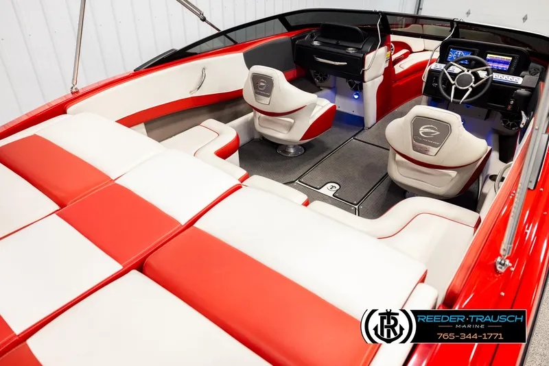 Slide: The Image of 2022 Crownline 220 LPX boat interior with red and white seating, modern dashboard, and steering wheel. - 12