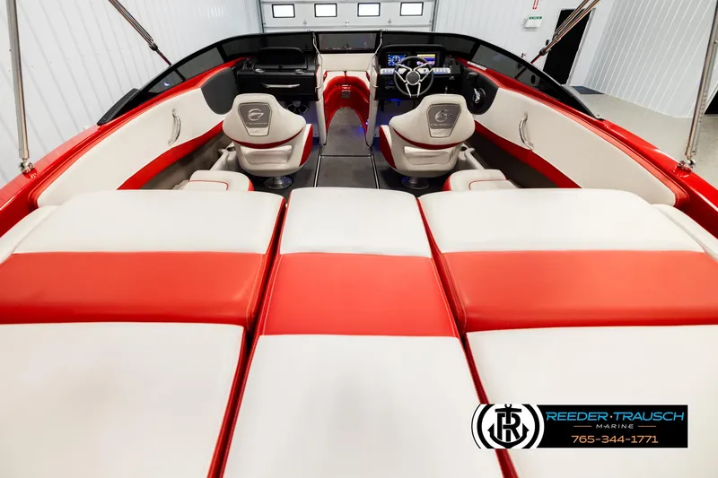 Slide: The Image of 2022 Crownline 220 LPX boat interior with red and white seating, steering wheel, and dashboard. - 13