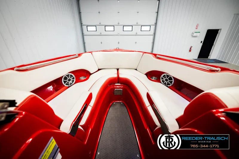 Slide: The Image of 2022 Crownline 220 LPX boat interior with red and white seating, speakers, and sleek design. - 15