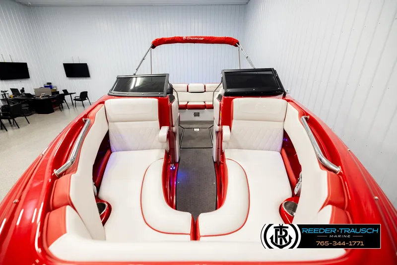 Slide: The Image of 2022 Crownline 220 LPX boat interior with red and white seating, displayed indoors. - 17