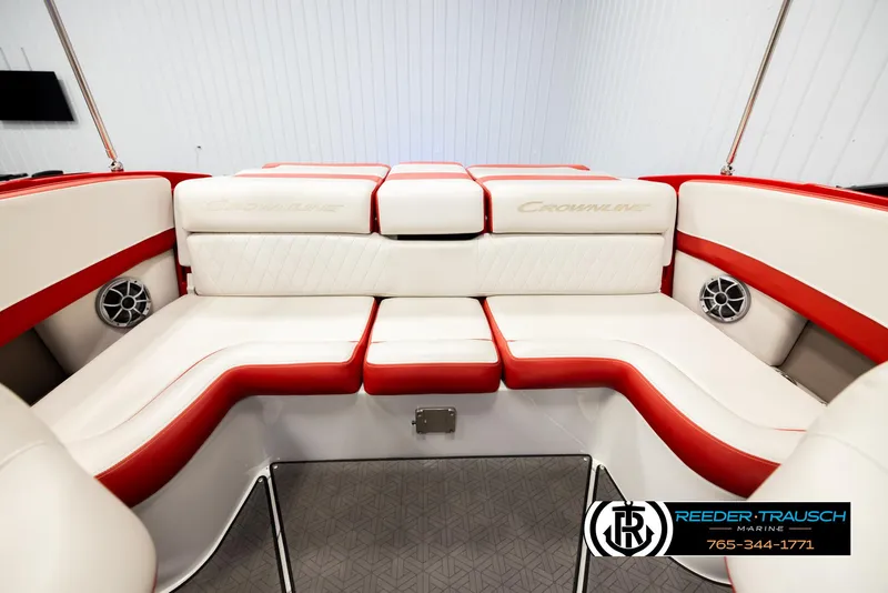 Slide: The Image of 2022 Crownline 220 LPX boat interior with red and white seating, featuring speakers. - 19