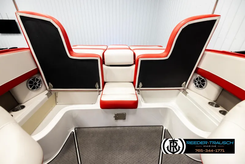 Slide: The Image of 2022 Crownline 220 LPX boat interior with red and white seating, speakers, and cup holders. - 21