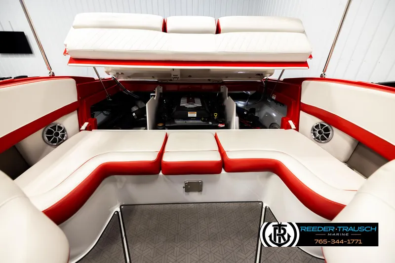 Slide: The Image of 2022 Crownline 220 LPX boat interior with red and white seating, open engine compartment. - 22