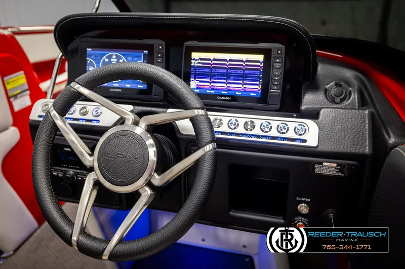 Slide: The Image of 2022 Crownline 220 LPX dashboard with Garmin displays and steering wheel. - 25