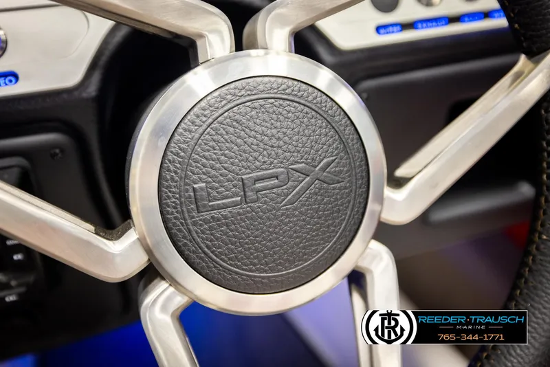 Slide: The Image of Steering wheel of 2022 Crownline 220 LPX boat, featuring LPX logo. - 27