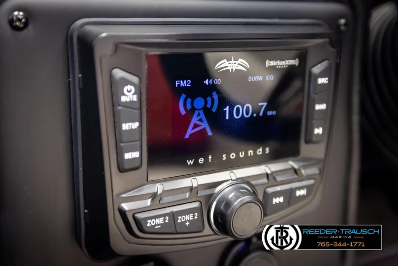 Slide: The Image of Crownline 220 LPX 2022 boat stereo system displaying FM radio station 100.7 MHz. - 28