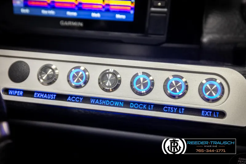 Slide: The Image of Dashboard controls of 2022 Crownline 220 LPX boat with illuminated buttons. - 32