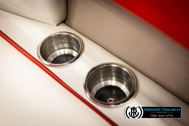 Slide: The Image of Cup holders on 2022 Crownline 220 LPX boat with red and white interior. - 35