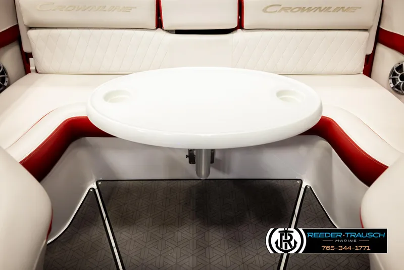 Slide: The Image of 2022 Crownline 220 LPX boat interior with white and red seating and a round table. - 43