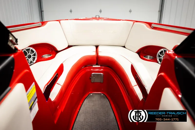 Slide: The Image of 2022 Crownline 220 LPX boat interior with red and white seating, speakers, and cup holders. - 44