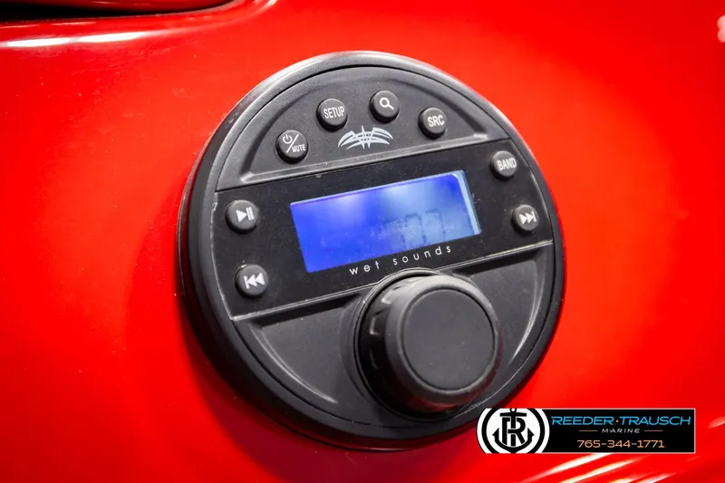 Slide: The Image of Close-up of a 2022 Crownline 220 LPX audio control panel on a red surface. - 47