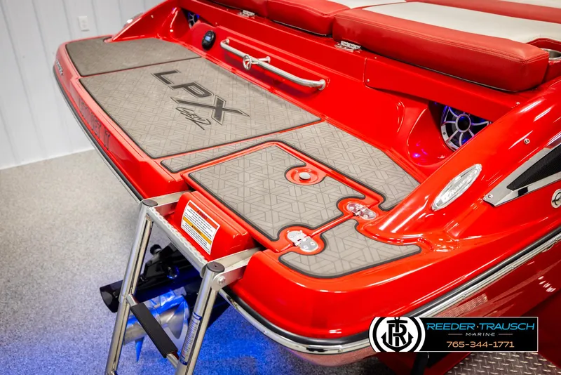 Slide: The Image of 2022 Crownline 220 LPX boat with red deck and swim platform. - 48