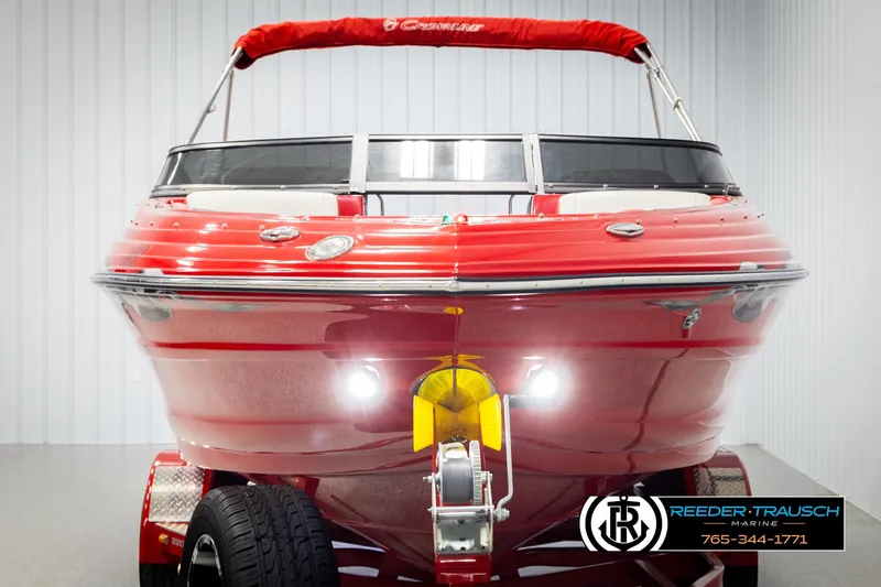 Slide: The Image of Red 2022 Crownline 220 LPX boat on trailer, front view, in showroom. - 8