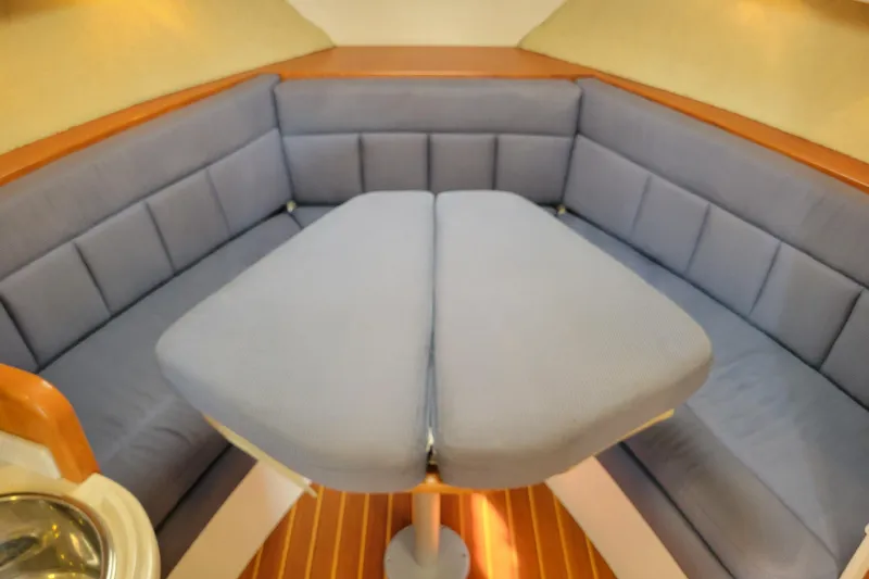 Slide: The Image of Interior of 1998 Cabo 31 Express with Tower, featuring a cozy seating area. - 17