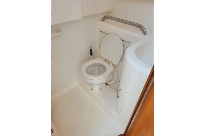 Slide: The Image of 1998 Cabo 31 Express boat bathroom with toilet and sink. - 20