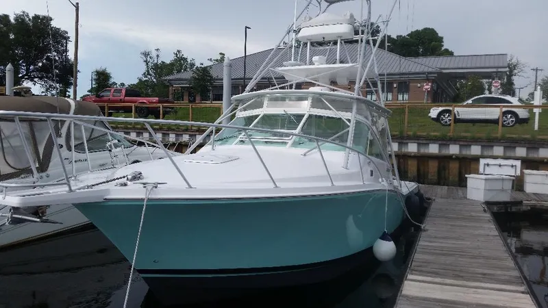 Slide: The Image of 1998 Cabo 31 Express with Tower docked at marina. - 27