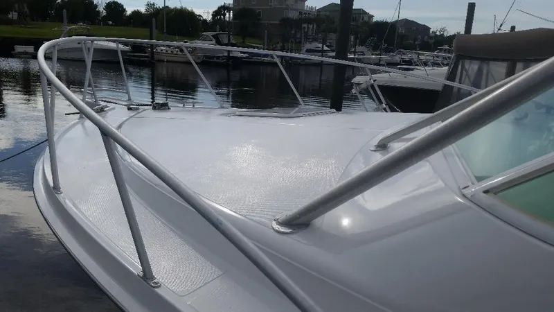 Slide: The Image of 1998 Cabo 31 Express with Tower docked in marina. - 28