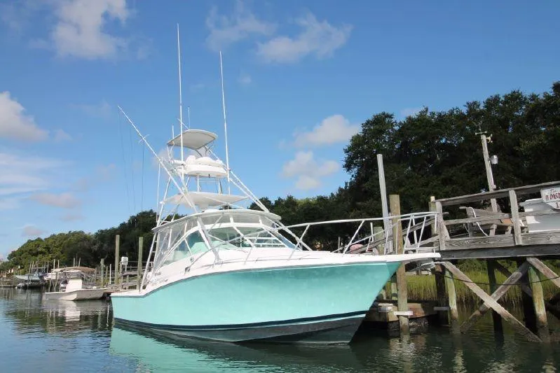 Slide: The Image of 1998 Cabo 31 Express with Tower, docked at pier. - 3