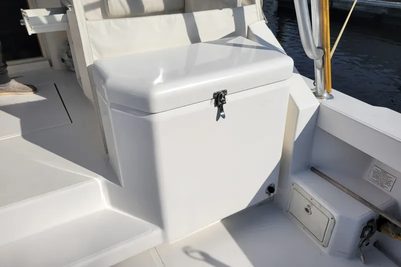 Slide: The Image of 1998 Cabo 31 Express with Tower, featuring a white deck and storage compartment. - 33