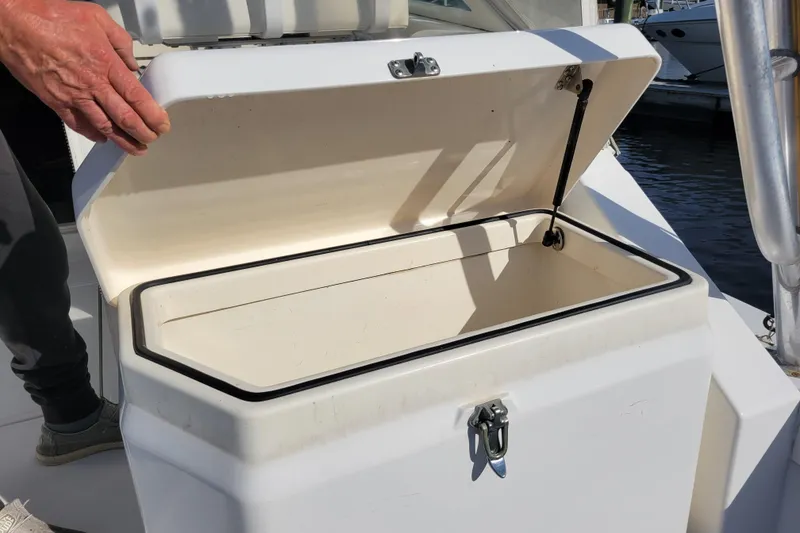 Slide: The Image of Open storage compartment on 1998 Cabo 31 Express boat, showing interior details. - 35