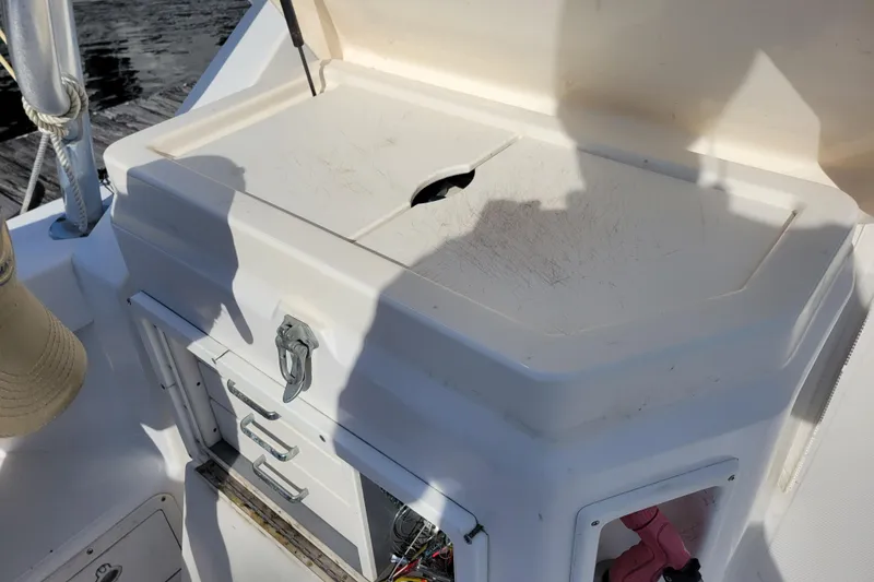 Slide: The Image of 1998 Cabo 31 Express boat with tower, featuring storage compartments and a work surface. - 36