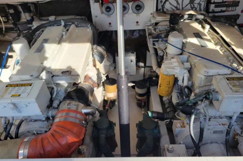 Slide: The Image of Engine room of a 1998 Cabo 31 Express with Tower, showcasing dual engines and components. - 37