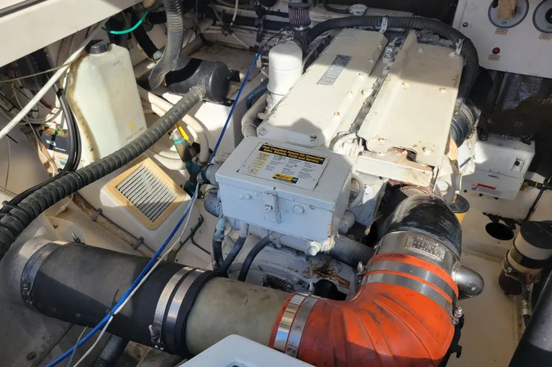 Slide: The Image of Engine compartment of a 1998 Cabo 31 Express with Tower, showcasing mechanical components. - 38