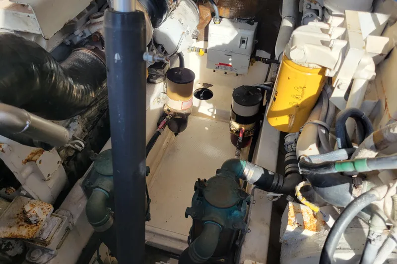 Slide: The Image of Engine room of 1998 Cabo 31 Express with Tower, showcasing mechanical components and piping. - 40
