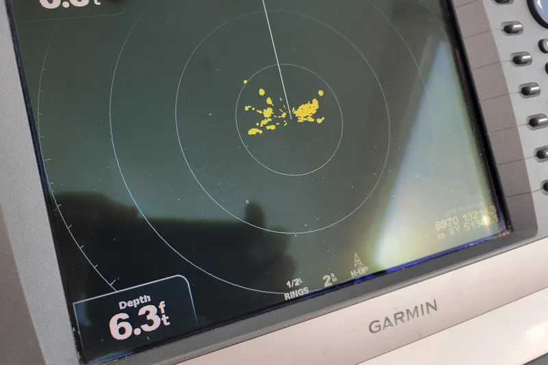 Slide: The Image of Garmin marine radar display showing depth of 6.3 feet on Cabo 31 Express, 1998 model. - 6