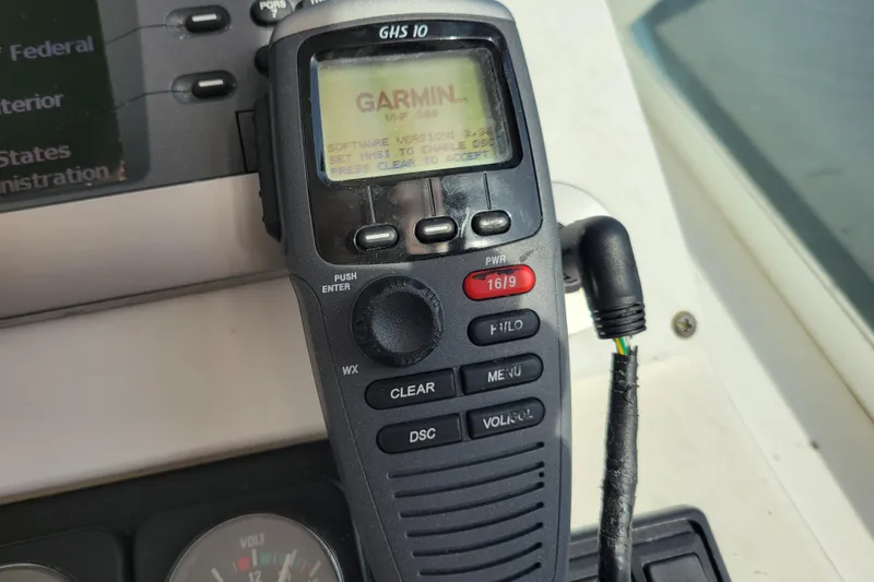 Slide: The Image of Garmin GHS 10 marine radio on 1998 Cabo 31 Express boat dashboard. - 7