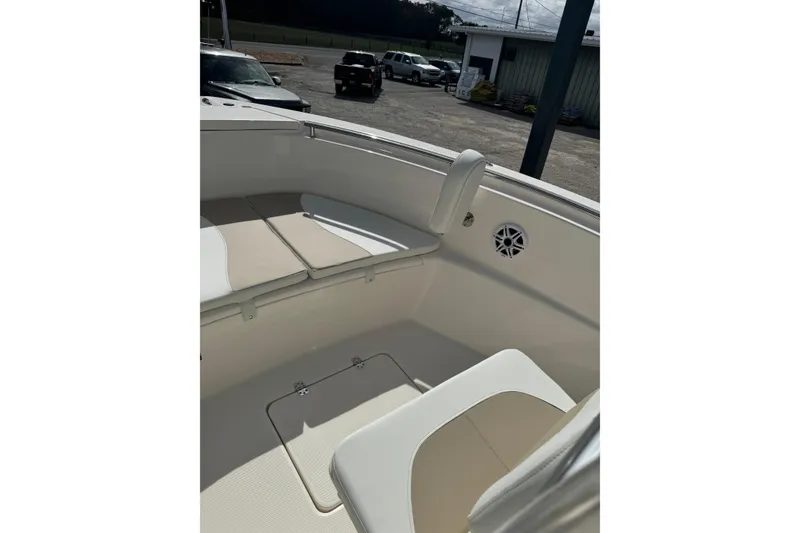 Slide: The Image of 2026 Bulls Bay 230 CC boat interior with cushioned seating and storage compartment. - 8