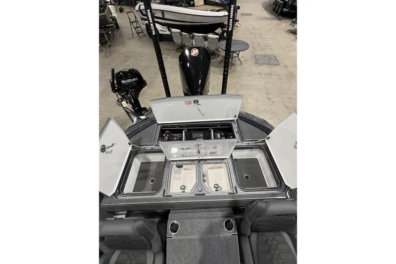 Slide: The Image of 2026 Vexus boat interior with open storage compartments and Suzuki outboard motor. - 9