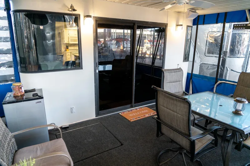 Slide: The Image of Houseboat interior with glass table, chairs, and mini fridge, Lakeview 66 x 16 Widebody, 1996. - 18