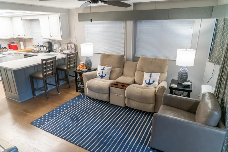 Slide: The Image of Interior of 1996 Lakeview houseboat with cozy seating, nautical decor, and modern kitchen. - 21