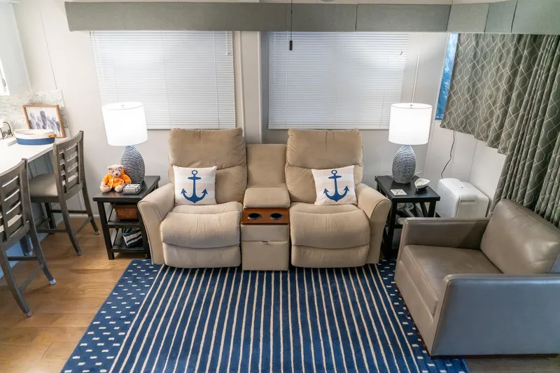 Slide: The Image of Cozy living area in 1996 Lakeview houseboat with recliners, nautical decor, and striped rug. - 22