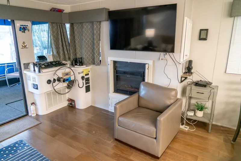 Slide: The Image of Interior of 1996 Lakeview 66 x 16 Widebody Houseboat with helm, TV, and fireplace. - 25