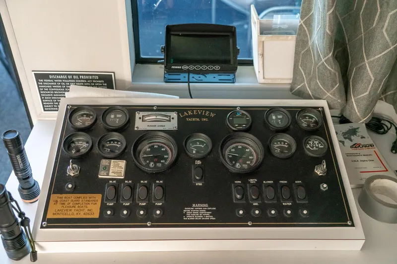 Slide: The Image of Control panel of a 1996 Lakeview 66 x 16 Widebody Houseboat with gauges and switches. - 28