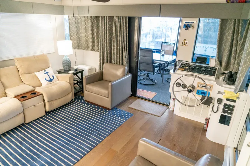 Slide: The Image of Interior of 1996 Lakeview 66 x 16 Widebody Houseboat with cozy seating and helm. - 30