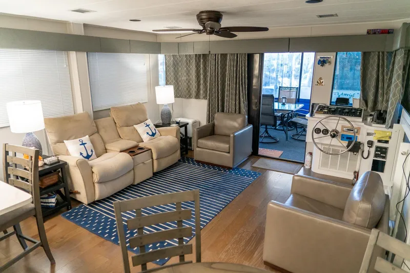 Slide: The Image of Interior of 1996 Lakeview 66 x 16 Widebody Houseboat with cozy seating and nautical decor. - 31