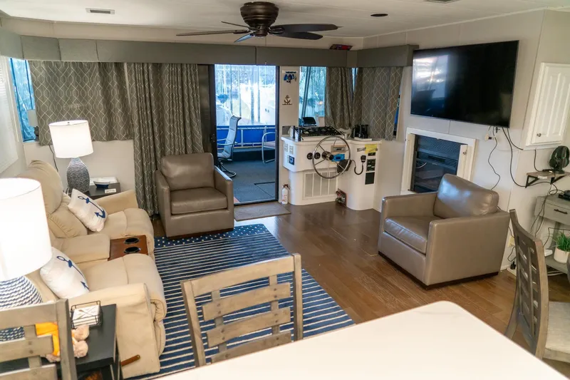 Slide: The Image of Interior of 1996 Lakeview 66 x 16 Widebody Houseboat with modern furnishings and large TV. - 33