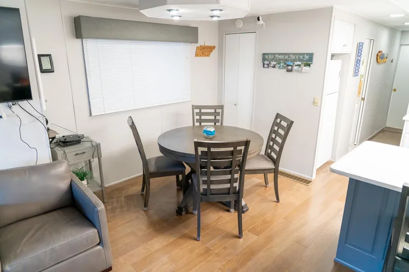 Slide: The Image of Interior of 1996 Lakeview 66 x 16 Widebody Houseboat with dining area and modern decor. - 34