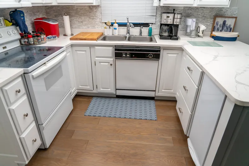 Slide: The Image of Modern kitchen in 1996 Lakeview 66 x 16 Widebody Houseboat with white cabinets and appliances. - 41