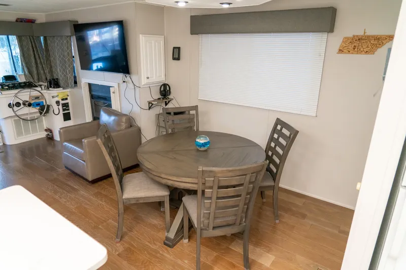 Slide: The Image of Interior of 1996 Lakeview 66 x 16 Widebody Houseboat with dining area and helm. - 43