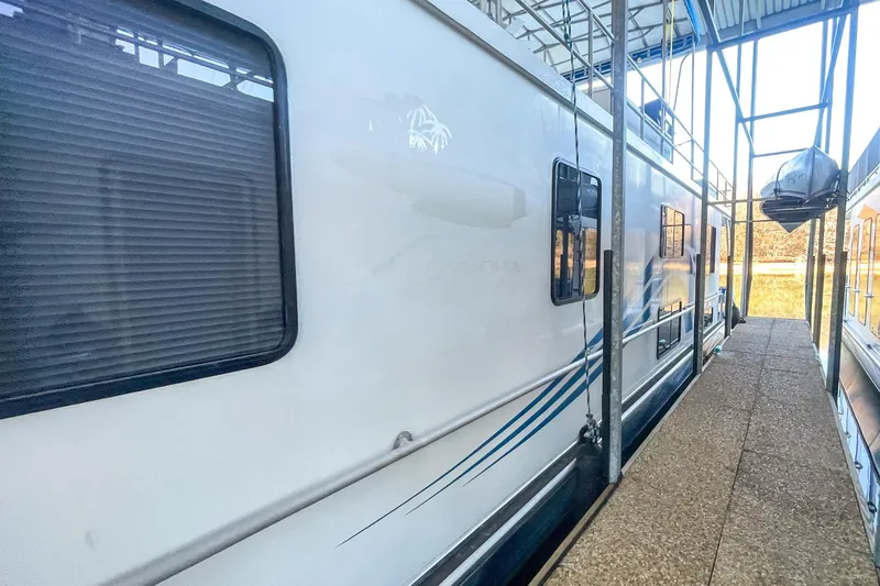 Slide: The Image of 1996 Lakeview 66 x 16 Widebody Houseboat docked in a marina. - 5